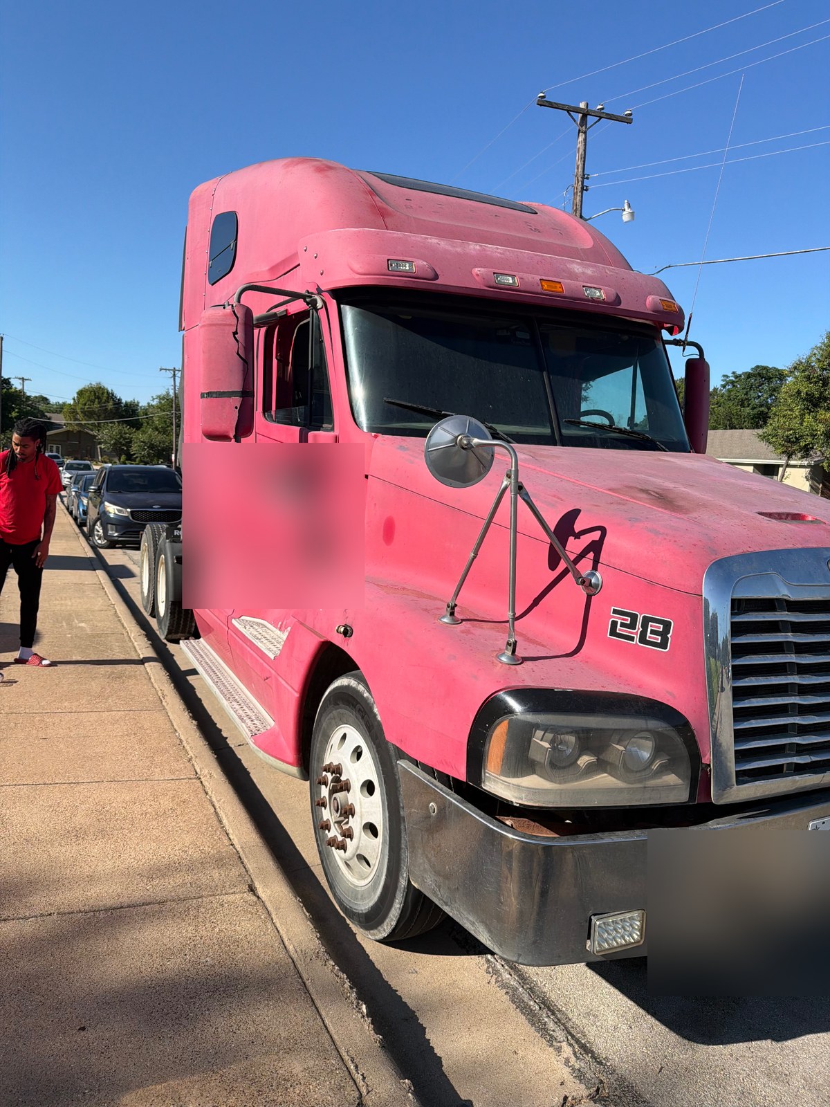 Freightliner Century Class sleeper cab receiving a 24V diesel jump start from All Hours Roadside in the DFW metro (license plate and DOT numbers blurred for privacy)