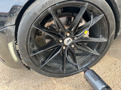 Curb-damaged McLaren forged wheel with Pirelli P-Zero PNCS sidewall bubble — repaired by All Hours Roadside in Dallas
