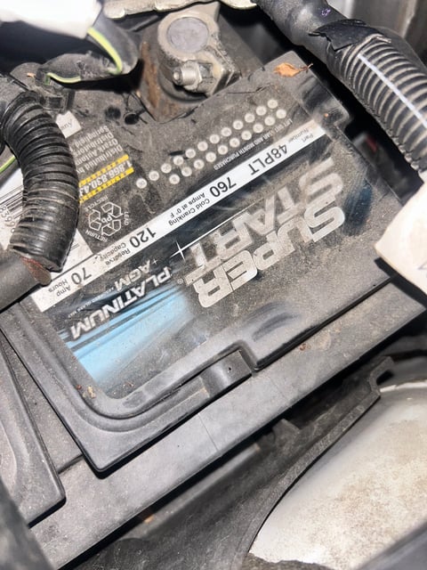 Corroded factory Super Start Platinum AGM 48PLT 760 CCA battery inside the engine bay of a 2022 Land Rover before mobile replacement — All Hours Roadside, Austin TX
