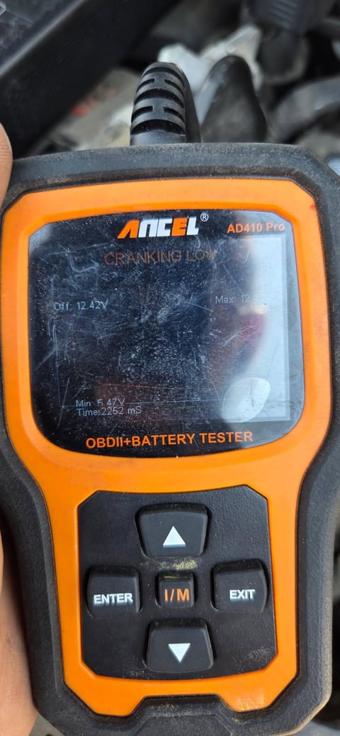 ANCEL AD410 Pro battery tester screen showing CRANKING LOW verdict — Off 12.42V, Min 5.47V, Time 2252 mS — captured on a Dallas mobile battery call — All Hours Roadside