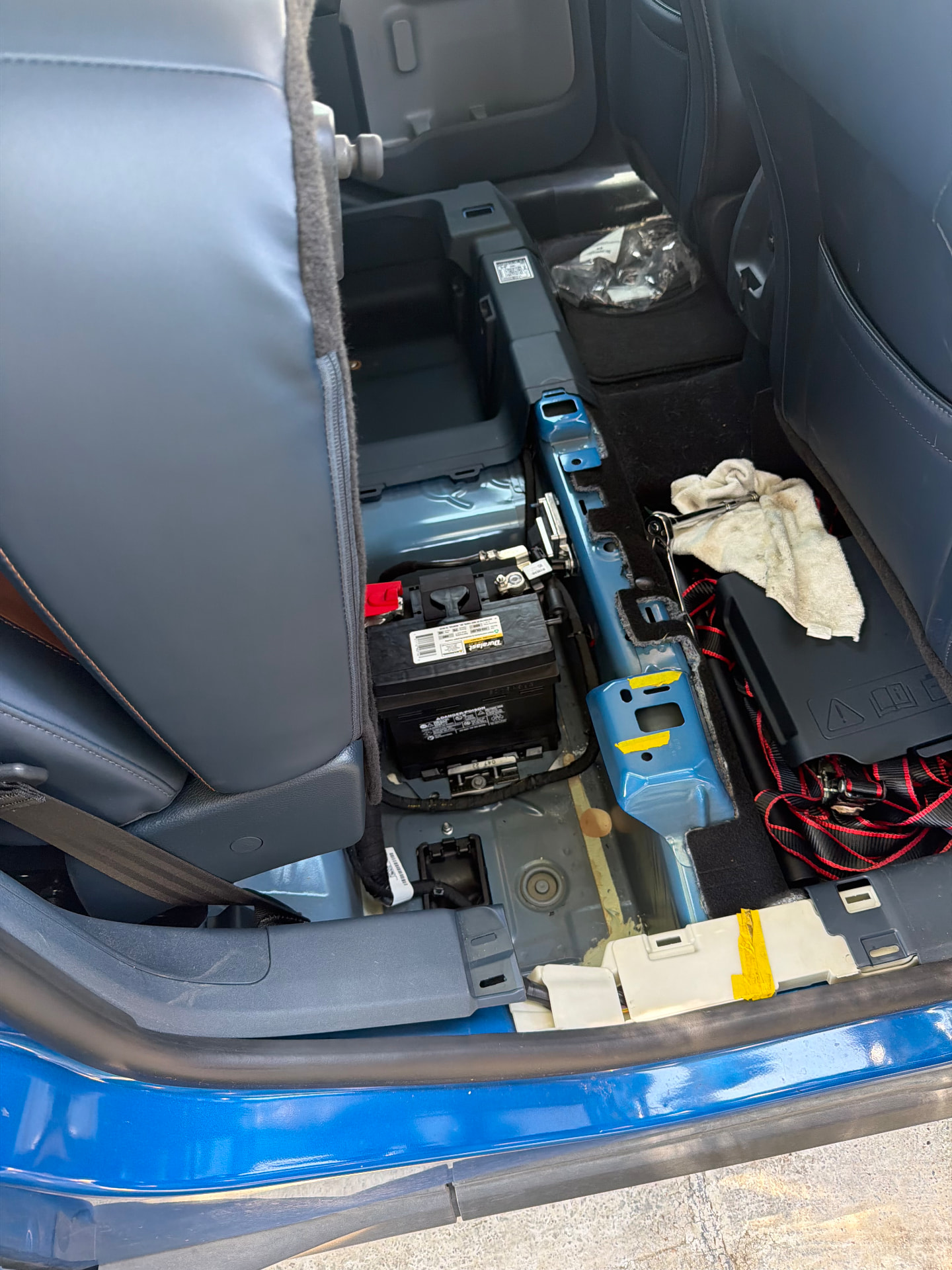 Ford Maverick hybrid with the hood up and a replacement 12V battery being installed on site by an All Hours Roadside technician in DFW