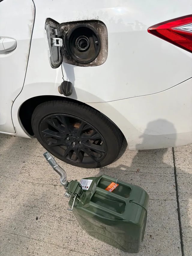 White Toyota Corolla out of gas in the DFW metro with a 5-gallon VEVOR jerry can staged at the open fuel door — All Hours Roadside 24/7 mobile fuel delivery